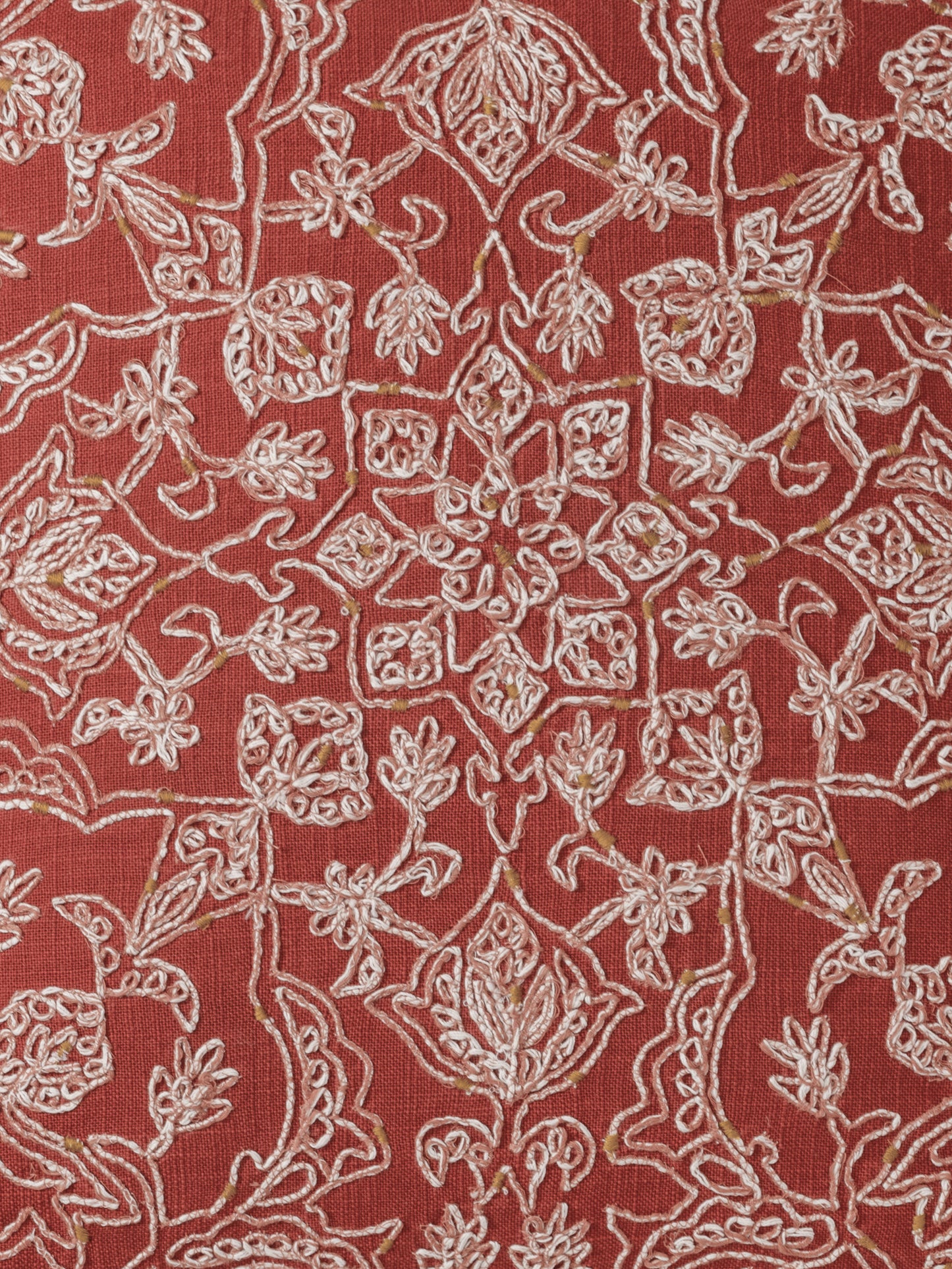 Close-up of stitch on cotton slub texture on coral pillow