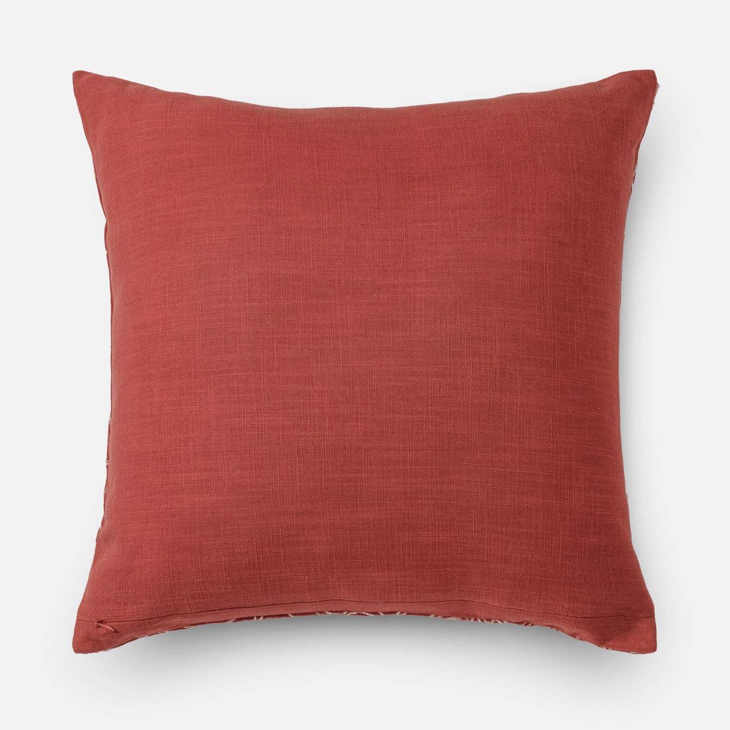 Textured coral pillow with subtle embroidery (back side of cushion)