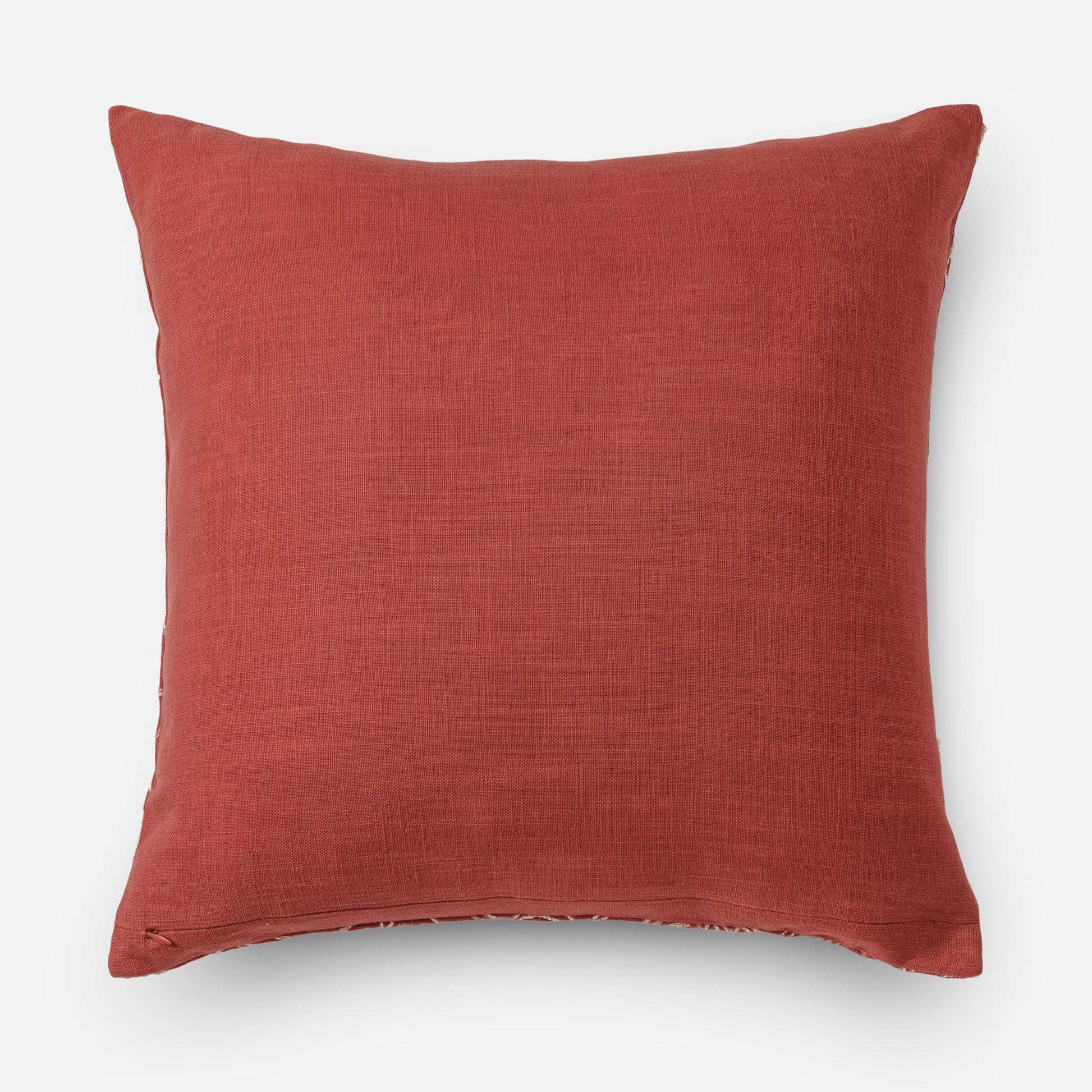 Textured coral pillow with subtle embroidery (back side of cushion)