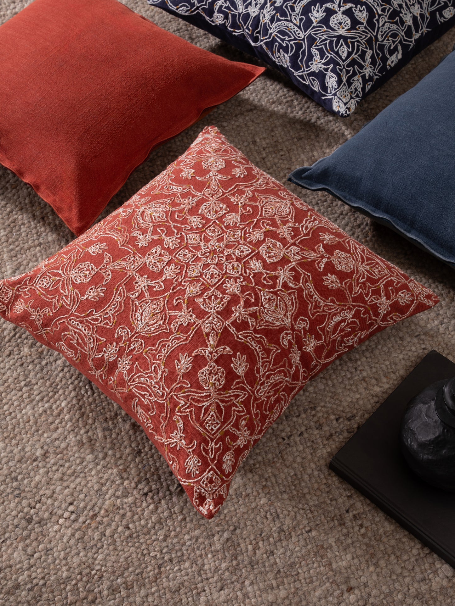 Vibrant coral decorative cushion styled in interior