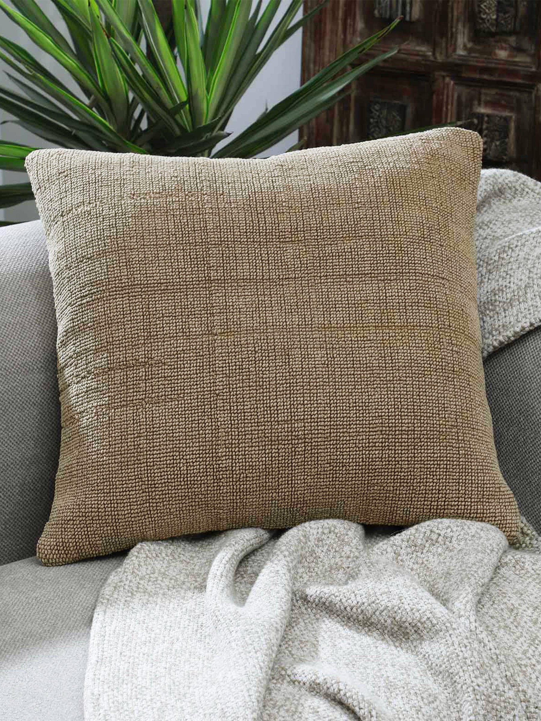 Architectural beige cushion styled in modern interior