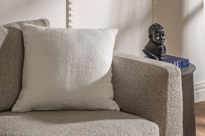 Minimal ivory linen pillow styled on sofa