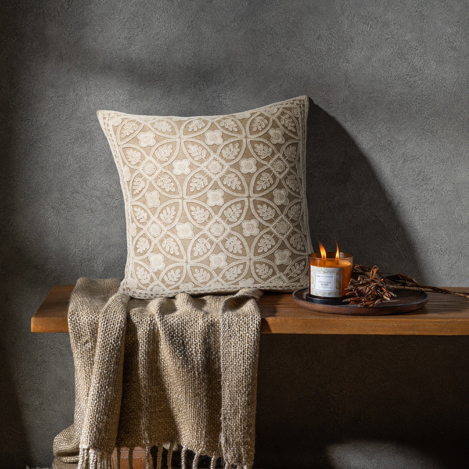 Structured embroidered cushion styled in neutral interior