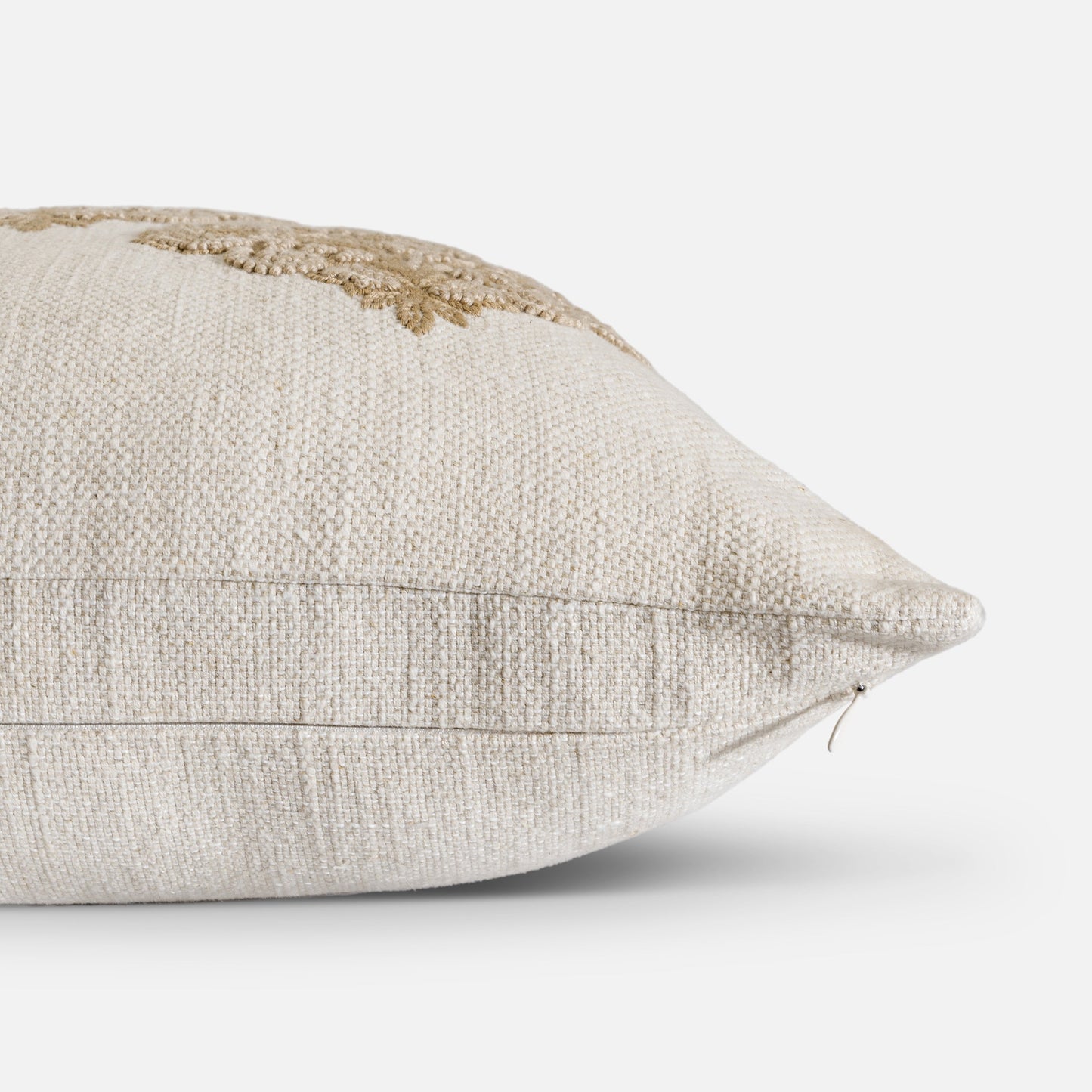Linen cushion with dimensional embroidery detail