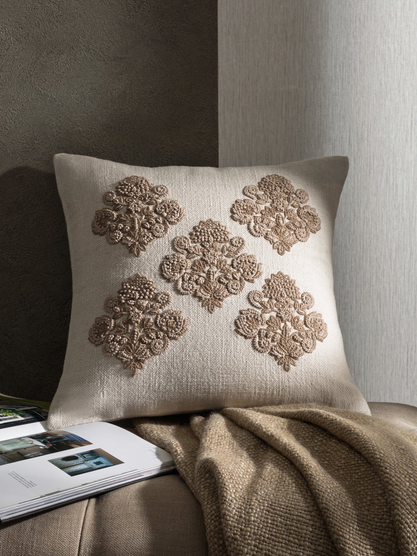 Decorative embroidered cushion styled in neutral interior