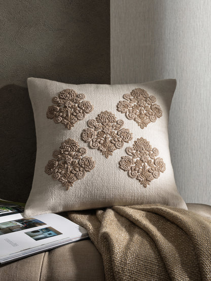 Decorative embroidered cushion styled in neutral interior