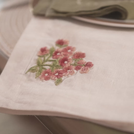Neutral table runner with decorative embroidery styled on table